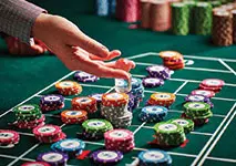 Roulette Player Placing Bets at Casino Table